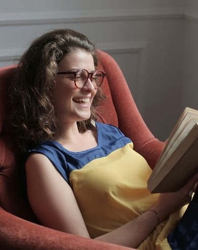 a girl in glasses with a book.