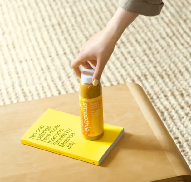 a bottle of smoothie on a book